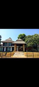 a large building with a staircase in front of it at Pai Woodland Resort in Pai