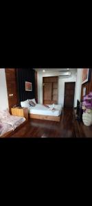 a large room with a bed and a mirror at Pai Woodland Resort in Pai