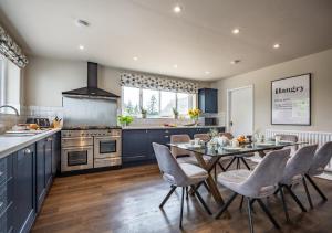 a kitchen with a table and chairs in a kitchen at Marrington Hall in Chirbury