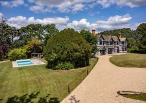 an estate with a large house and a swimming pool at Marrington Hall in Chirbury
