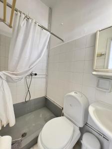 a bathroom with a toilet and a sink at Hotel Anezina in Drios