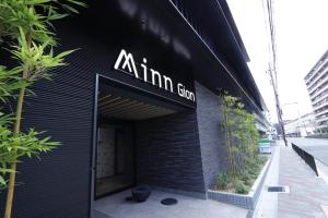 a black building with a sign on the side of it at Minn Gion in Gionmachi