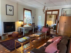 a living room with a couch and a table at Daisy Cottage in Nieu-Bethesda