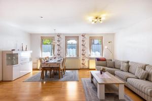 a living room with a couch and a table at Alb Rose Ferienwohnung in Sonnenbühl