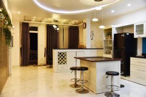 a kitchen with two bar stools and a counter at Thu Linh Villa in Da Lat