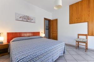 a bedroom with a bed and a table and a chair at Casa Castagnola in Marciana