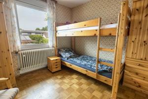 a bedroom with two bunk beds and a window at See- Panorama in Gaienhofen