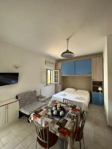 a bedroom with a bed and a table in a room at I Villini in Castellaneta Marina 