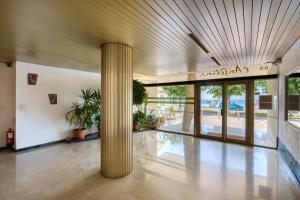 a lobby with a large column in a building at Studio En Bord De Mer in Cagnes-sur-Mer