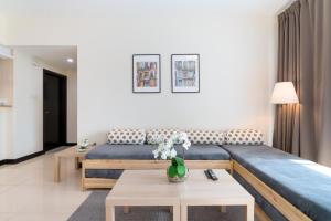 a living room with a couch and a table at White Sage - Gorgeous Apartment in JLT Near the Metro Station in Dubai