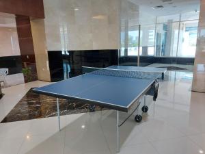 a ping pong table in the middle of a room at White Sage - Gorgeous Apartment in JLT Near the Metro Station in Dubai