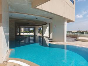 a swimming pool with blue water in a building at White Sage - Gorgeous Apartment in JLT Near the Metro Station in Dubai