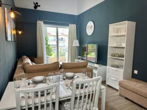 a living room with a table and a couch at ALF Apartments & Lofts in Leptokarya