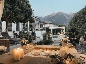 a patio with candles and a backyard with a house at Sunny Way Home Accommodation & Spa in Weite