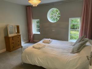a bedroom with a large white bed with a window at 3 The Mews in Ryde