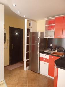 a kitchen with a refrigerator and a black door at APARTMENT 8 Primorsko АПАРТАМЕНТ 8 Приморско in Primorsko