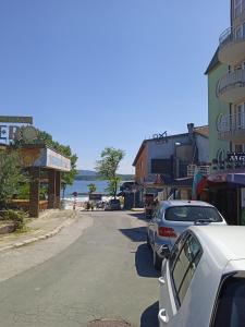 a street with cars parked on the side of a beach at APARTMENT 8 Primorsko АПАРТАМЕНТ 8 Приморско in Primorsko