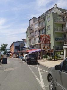 a parking lot with cars parked in front of a building at APARTMENT 8 Primorsko АПАРТАМЕНТ 8 Приморско in Primorsko +9 photos