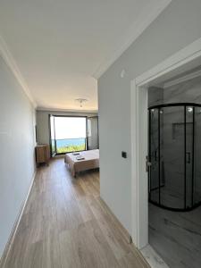 a bedroom with a bed and a glass door at Sea View Villa in Trabzon