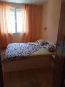 a bed in a small room with a window at APARTMENT 8 Primorsko АПАРТАМЕНТ 8 Приморско in Primorsko