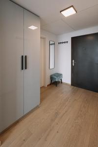 an empty room with a black door and a wooden floor at SKAU Blue Residence in Sky Park 21 floor 2 tower Panoramic View Free Parking in Bratislava