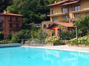 a swimming pool in front of a building at Casa Penny - Menaggio by LoveComo in Menaggio
