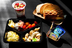 a table with two trays of food and bread at Central Apartments Warszawska Street in Krakow