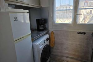 a kitchen with a refrigerator and a washing machine at Renovated apartment near the beach in Villers-sur-Mer