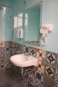 a bathroom with a sink and a mirror at Amango Dorm in Ho Chi Minh City