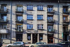 a building with cars parked in front of it at Central Apartments Warszawska Street in Krakow