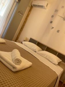 ein Hotelzimmer mit 2 Betten und Handtüchern darauf in der Unterkunft MY HOME PERISTERI in Athen