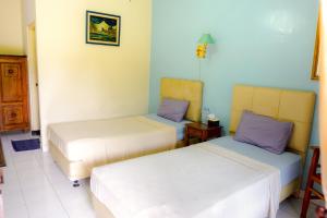 Giường trong phòng chung tại Hotel Tulips