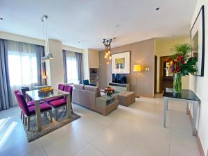 a living room with a couch and a table at One Pacific Place Serviced Residences in Manila