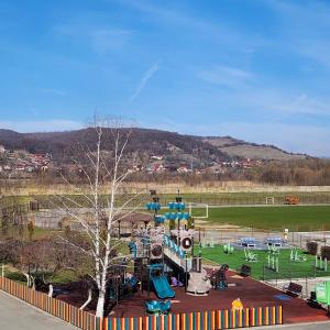 a playground with a slide in a park at My room accommodation in Curtea de Argeş