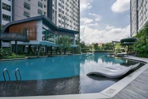 a swimming pool in the middle of a building at PlayStaytion Centura 3 Bedroom 2 Bathroom by RBNB in Kuala Lumpur