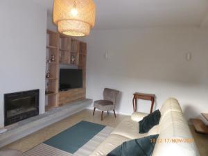 uma sala de estar com um sofá e uma lareira em La faustinière 