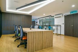 an office with a table and chairs and a person at PlayStaytion Centura 3 Bedroom 2 Bathroom by RBNB in Kuala Lumpur +76 photos