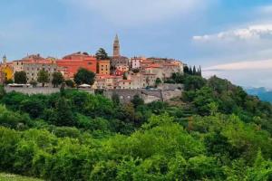 a town on top of a hill with trees at APARTMAN EDDA **** in Labin