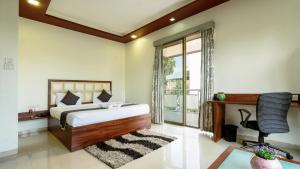 a bedroom with a bed and a desk and a chair at Magnus Vosiv Suites in Pune