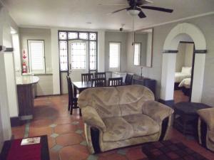 a living room with a couch and a dining room at Caribbean Estates Montego Bay 05 in Port Edward