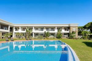 a swimming pool in front of a building at Apartament Belharucas, 400 meters from beach in Albufeira
