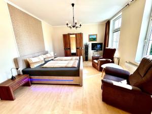 a living room with a bed and a couch at Haus Burmeister in Sassnitz