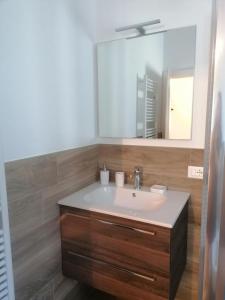 a bathroom with a sink and a mirror at Sweet Home Casa Vacanze il b&b in Songavazzo