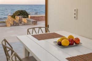 un plato de fruta en una mesa con vistas al océano en Ascuri Studio by Estia en Sissi