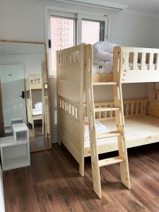 a room with two bunk beds and a mirror at Sunyhouse Female Only Foreign Only in Seoul