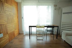 a dining room with a table and two chairs at Sunyhouse Female Only Foreign Only in Seoul