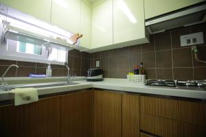 a kitchen with a sink and a counter top at Sunyhouse Female Only Foreign Only in Seoul