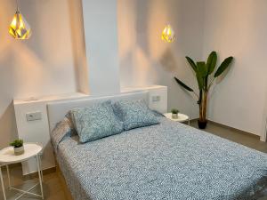 a bedroom with a bed with two pillows on it at Santa Pola Suites in Santa Pola