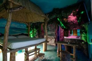 a bedroom with a bed with a canopy and a table at Hotel Carosello in Pontecagnano