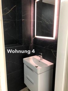 a bathroom with a white sink and a mirror at Zentrale Innenstadt-Wohnung in Würzburg +50 photos